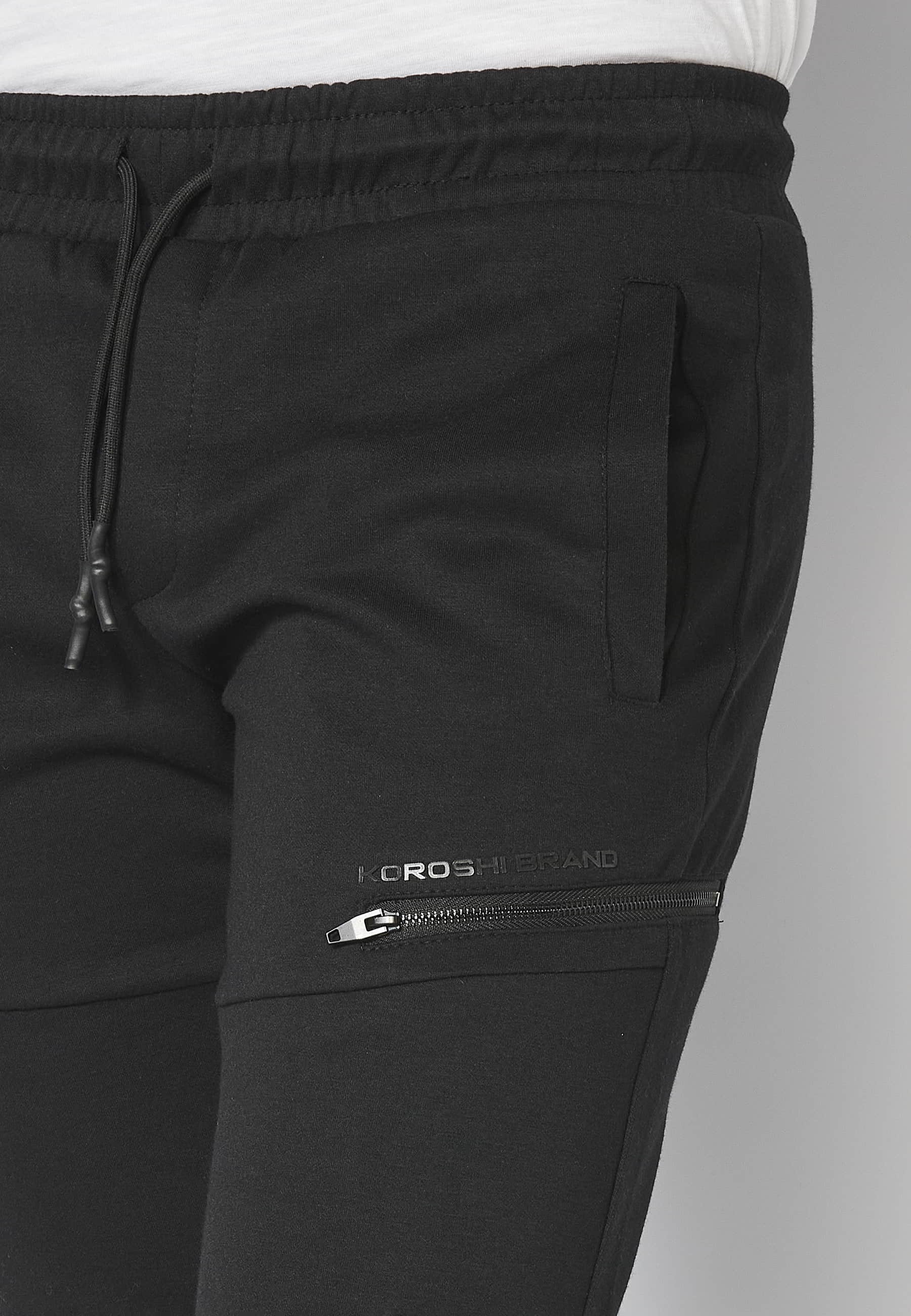 Pantalón Deportivo largo jogger con cintura engomada y cordón con cortes en las rodillas color Negro para Hombre