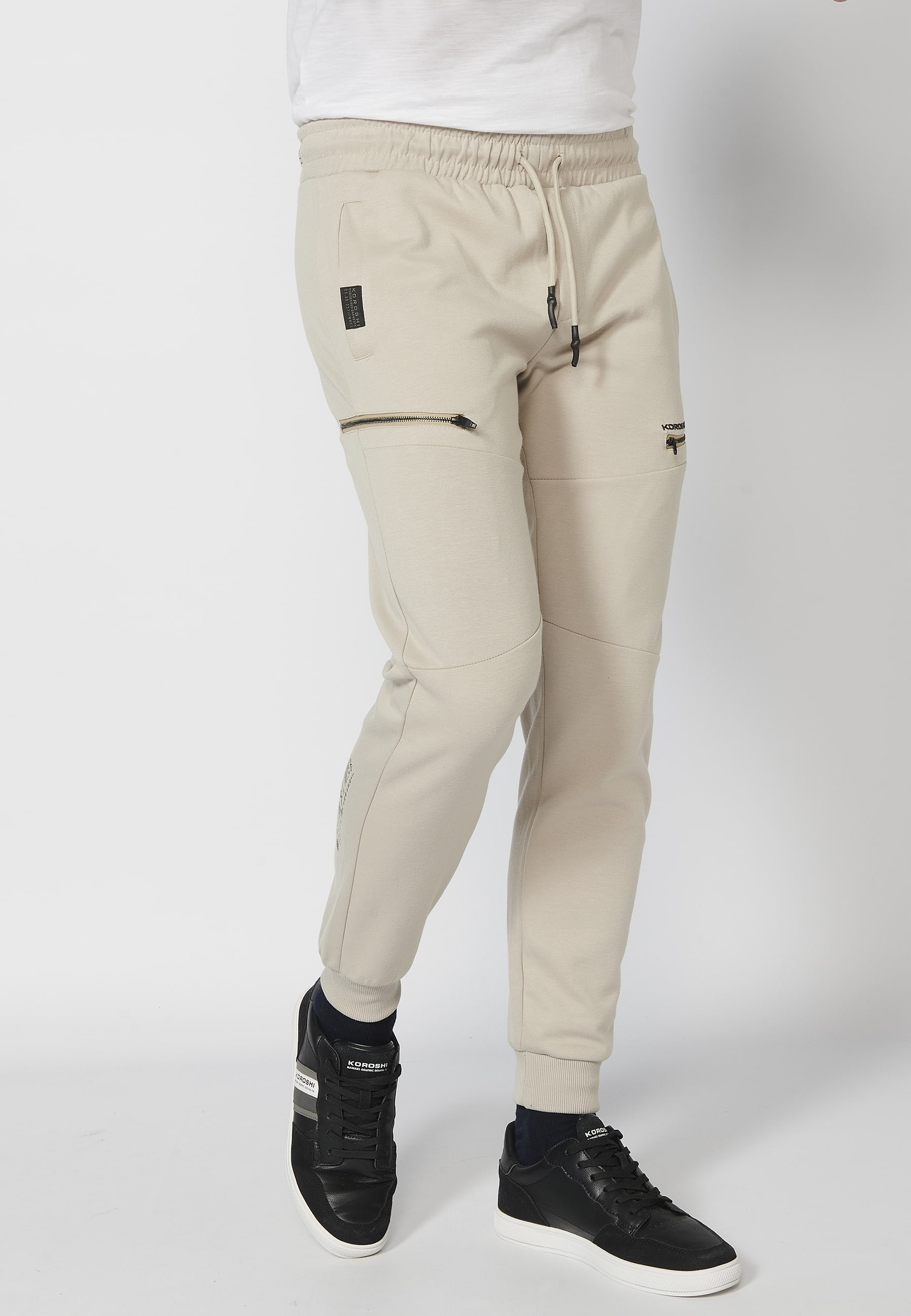 Long jogger pants with a rubberized waist and drawstring with cut-outs in the knees, Stone color, for Men 1
