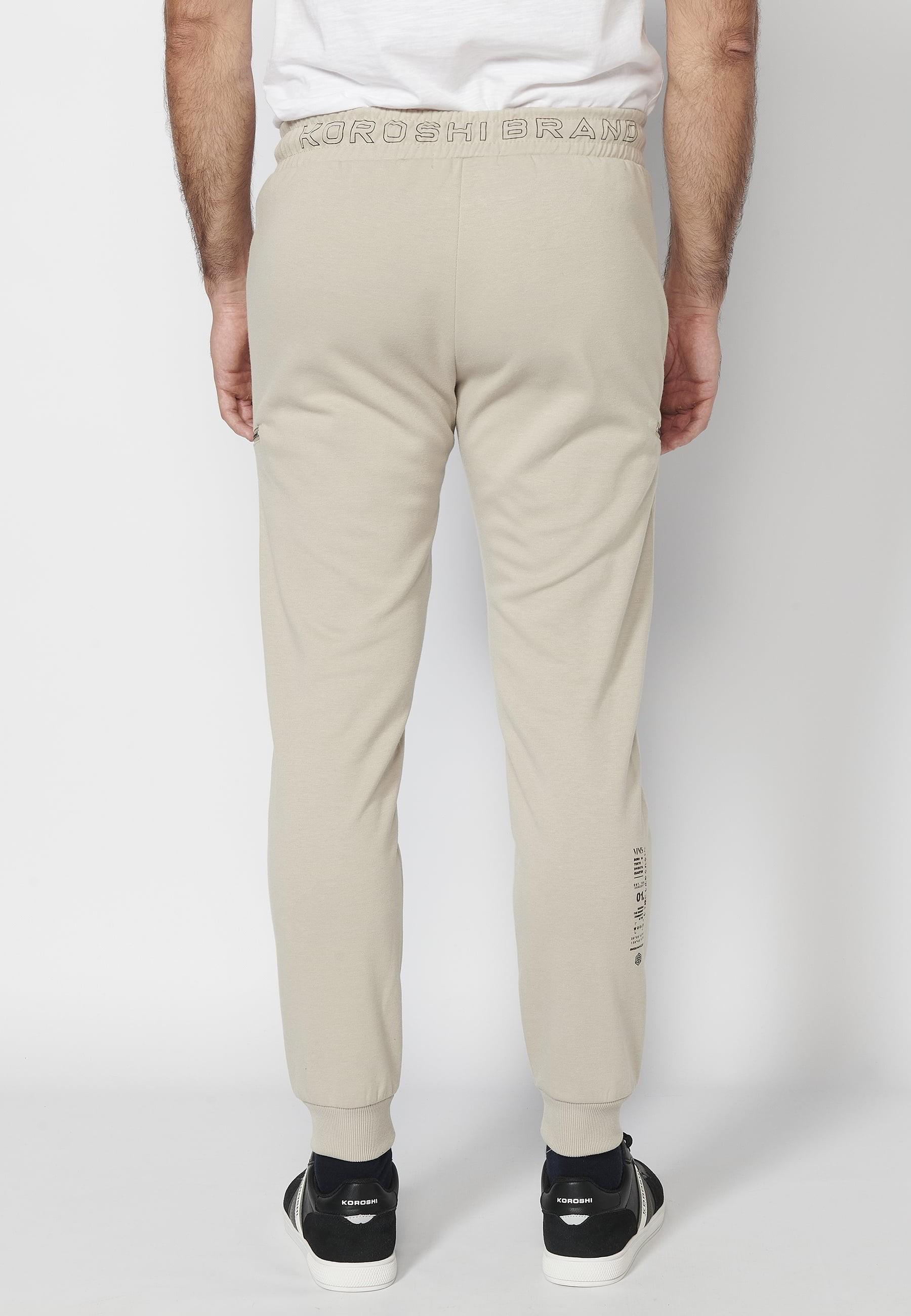 Pantalons llargs jogger amb cintura engomada i cordó amb talls als genolls color Pedra per a Home 3