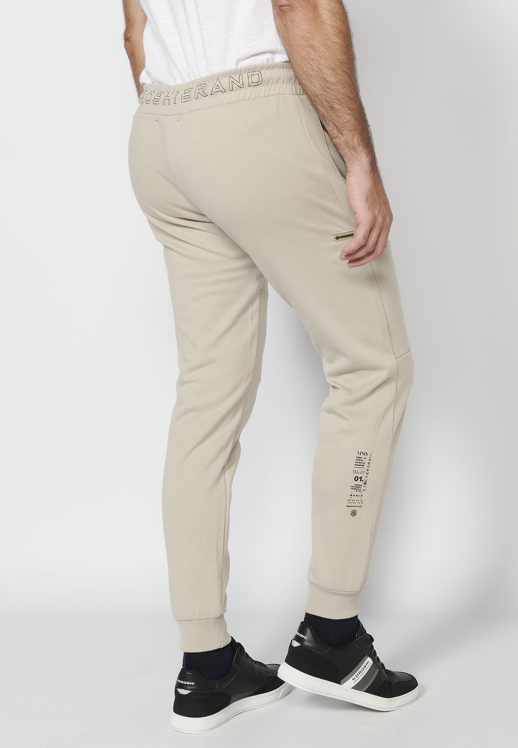 Long jogger pants with a rubberized waist and drawstring with cut-outs in the knees, Stone color, for Men 8