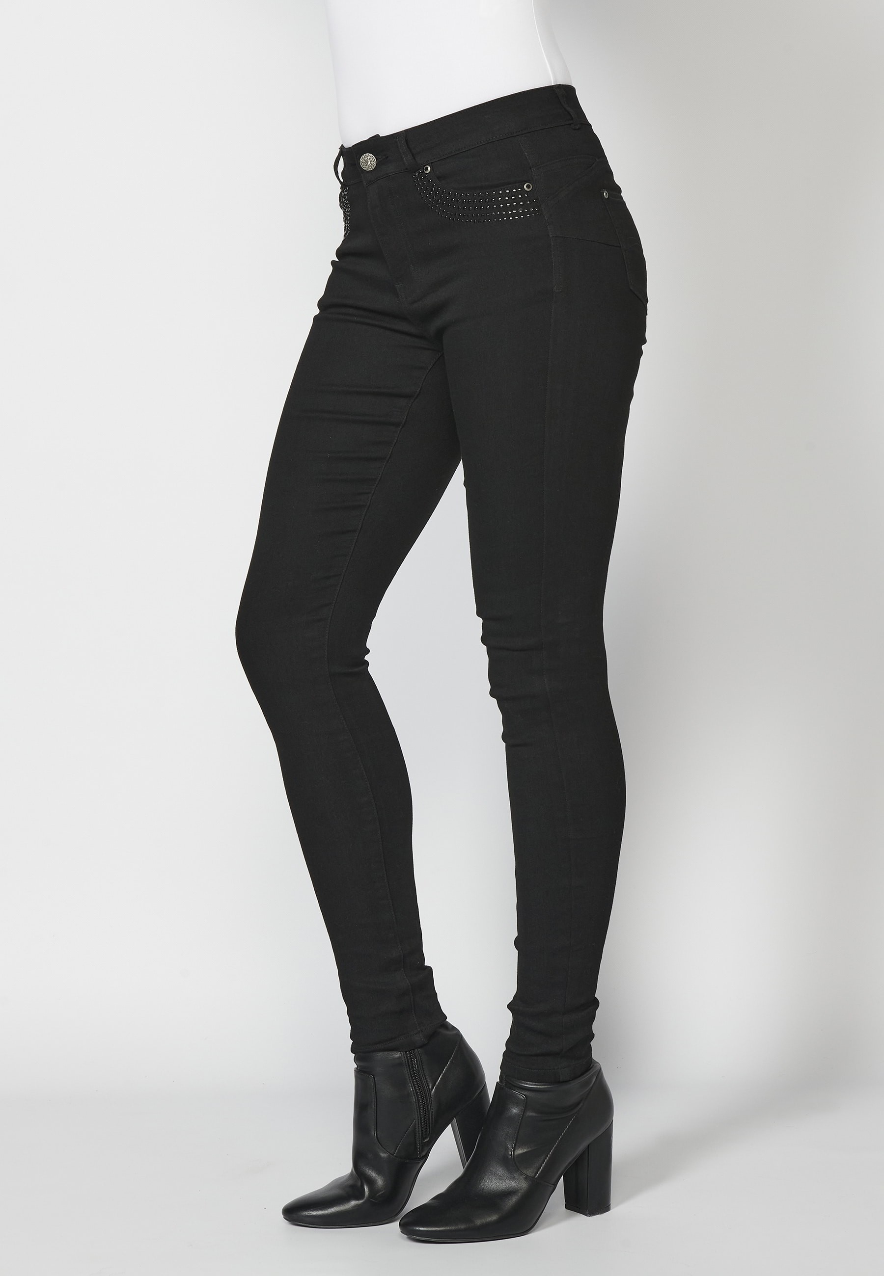 Long slim-fit jean pants with stud details on pockets in Black color for Woman