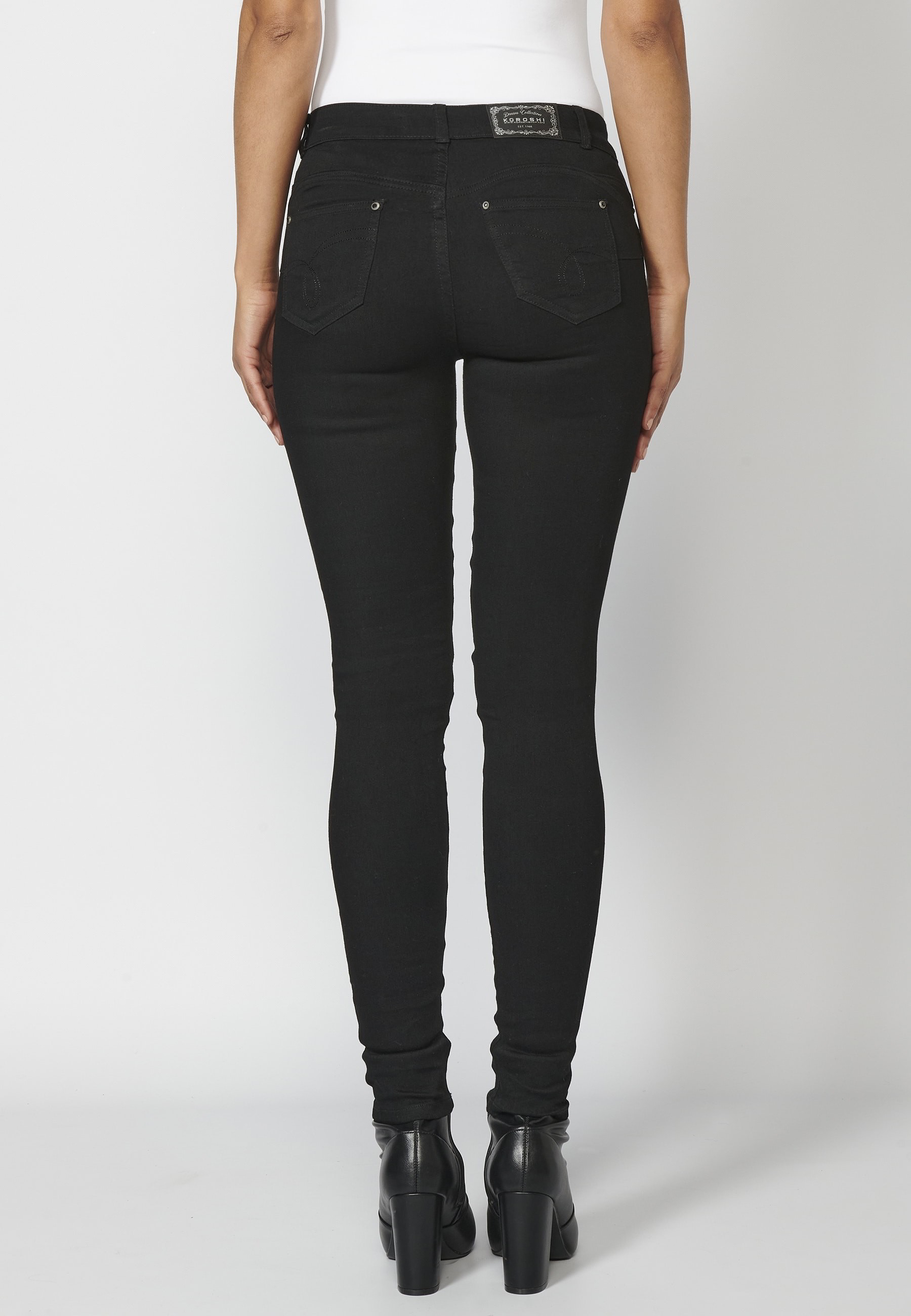 Long slim-fit jean pants with stud details on pockets in Black color for Woman