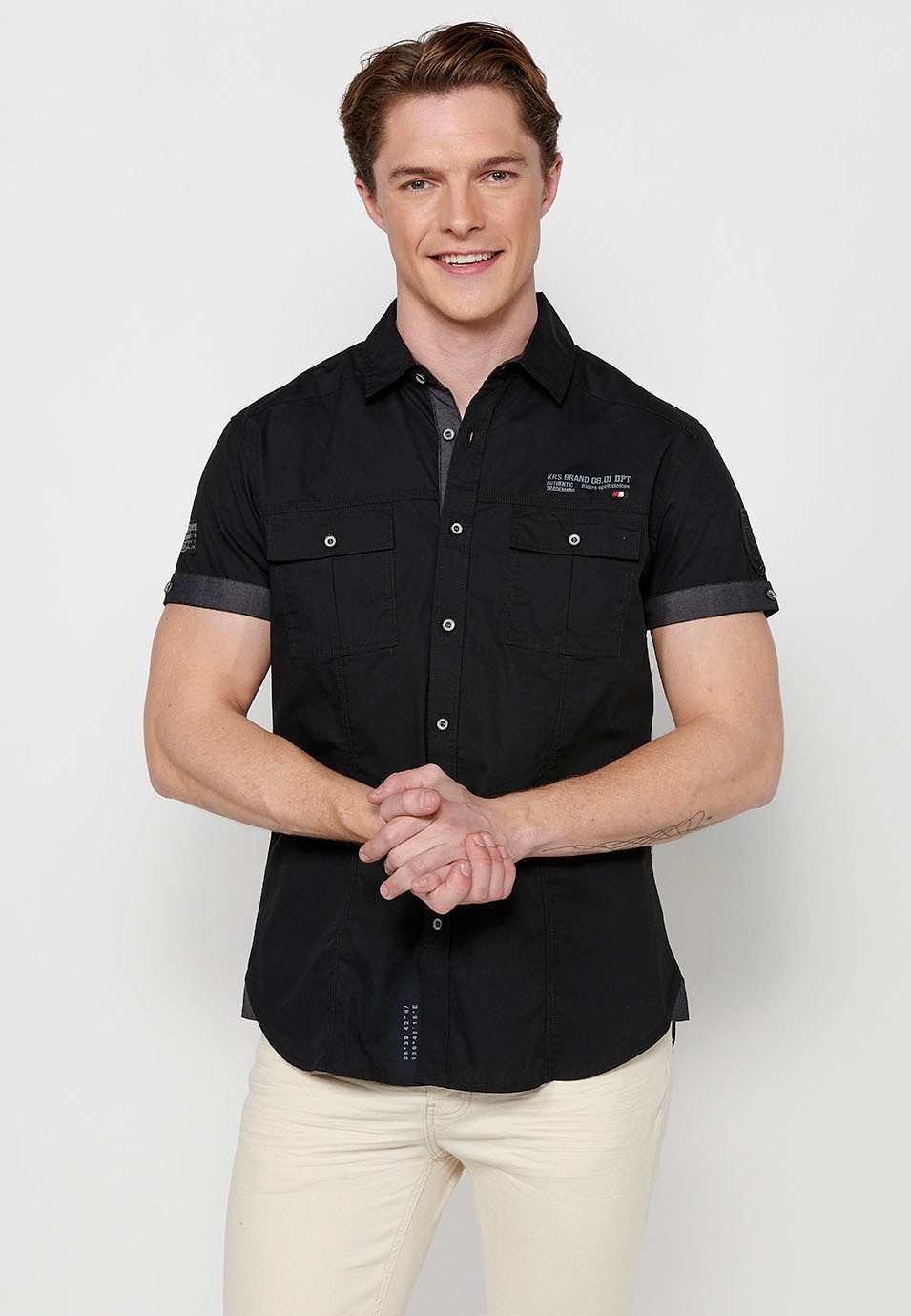 Chemise en coton à manches courtes avec fermeture boutonnée sur le devant et poches à rabat avant de couleur noir pour homme