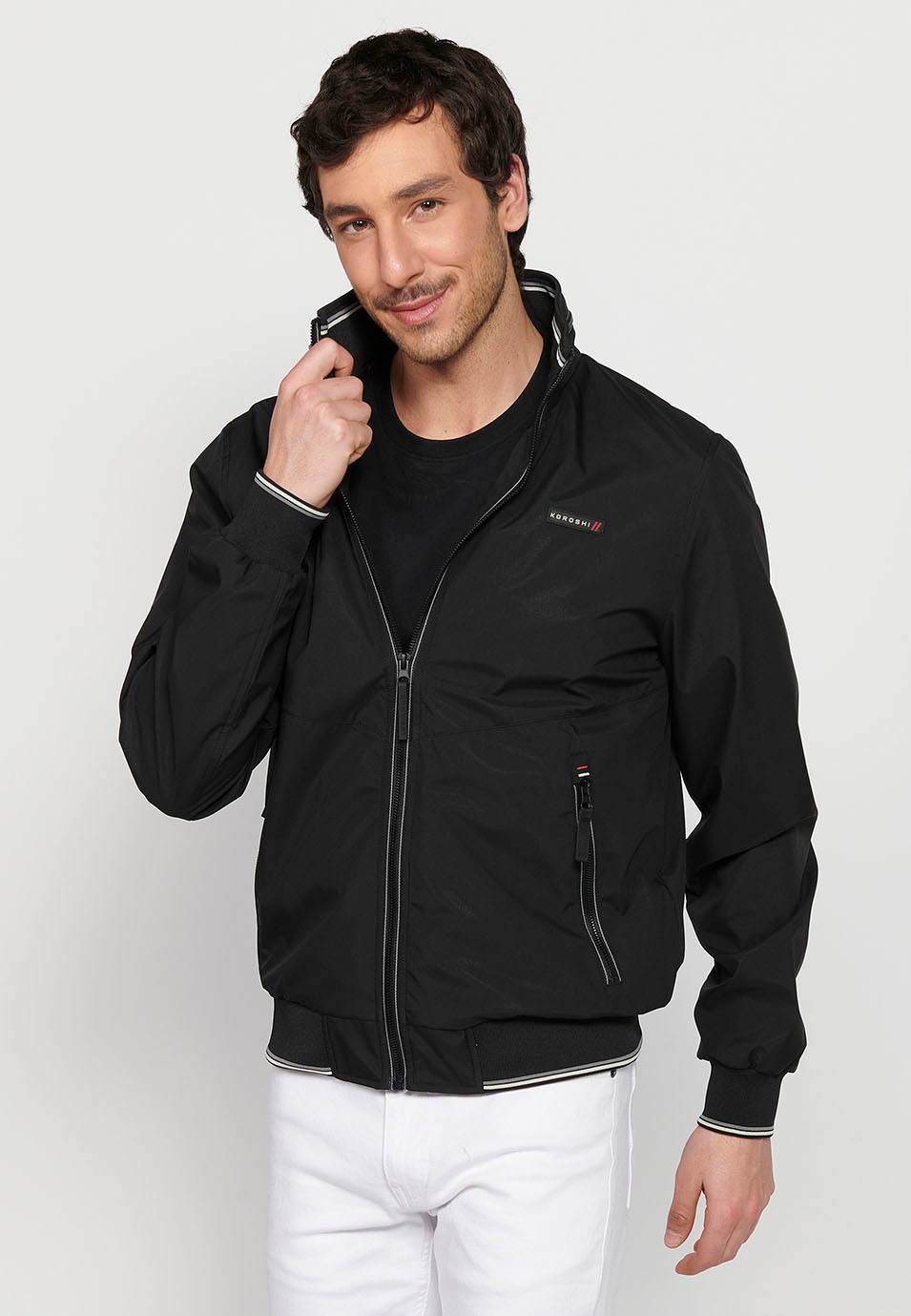 Long-sleeved high-neck windbreaker jacket with front zipper closure and ribbed finishes with pockets, one inside in Black for Men