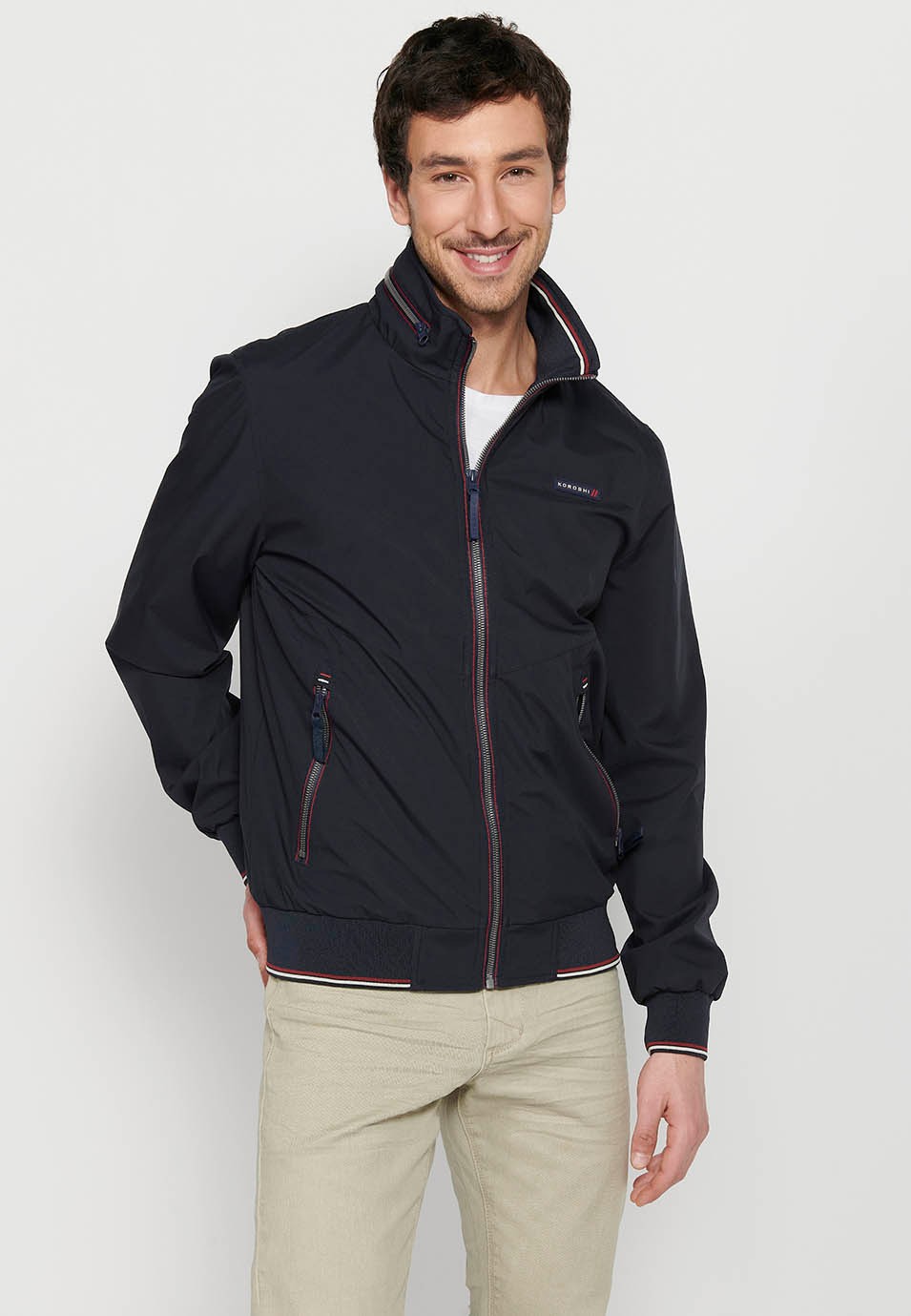 Long-sleeved high-neck jacket with front zipper closure and ribbed finishes with pockets, one inside in Navy for Men