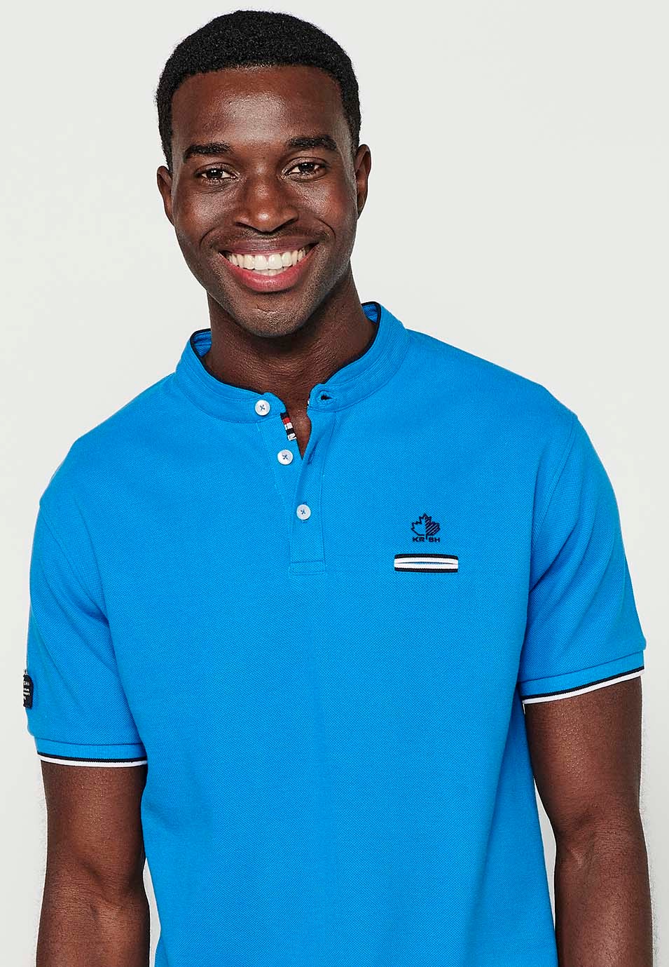 Kurzarm-Poloshirt aus Baumwolle mit geripptem Finish, Rundhalsausschnitt, geknöpfter Öffnung und Seitenschlitzen in Blau für Herren 1