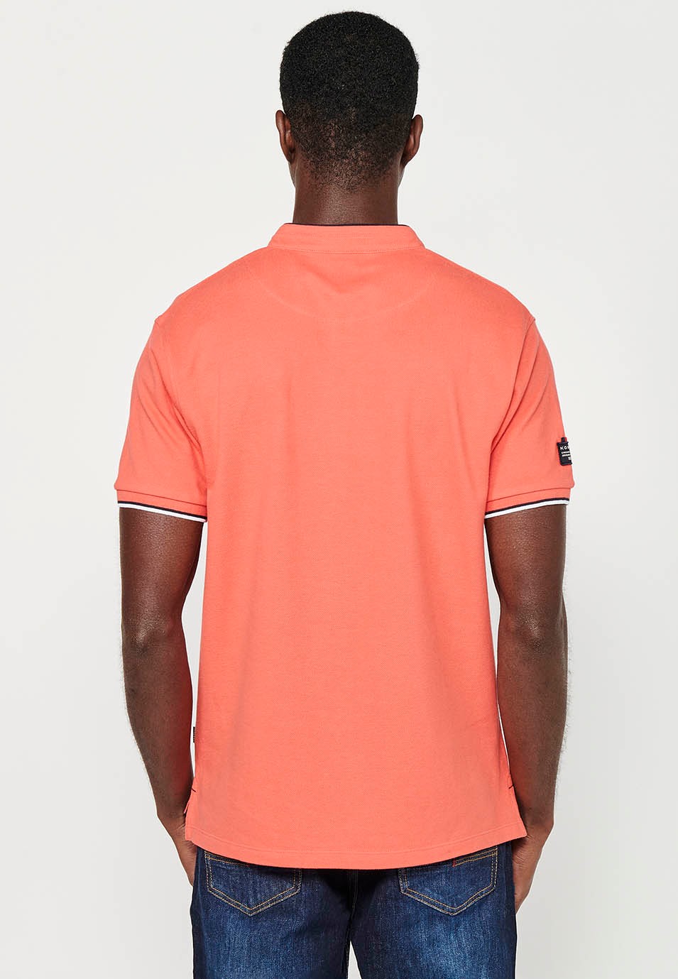 Short-sleeved cotton polo shirt with ribbed finish with round neck with buttoned opening and side slits in coral color for men 2
