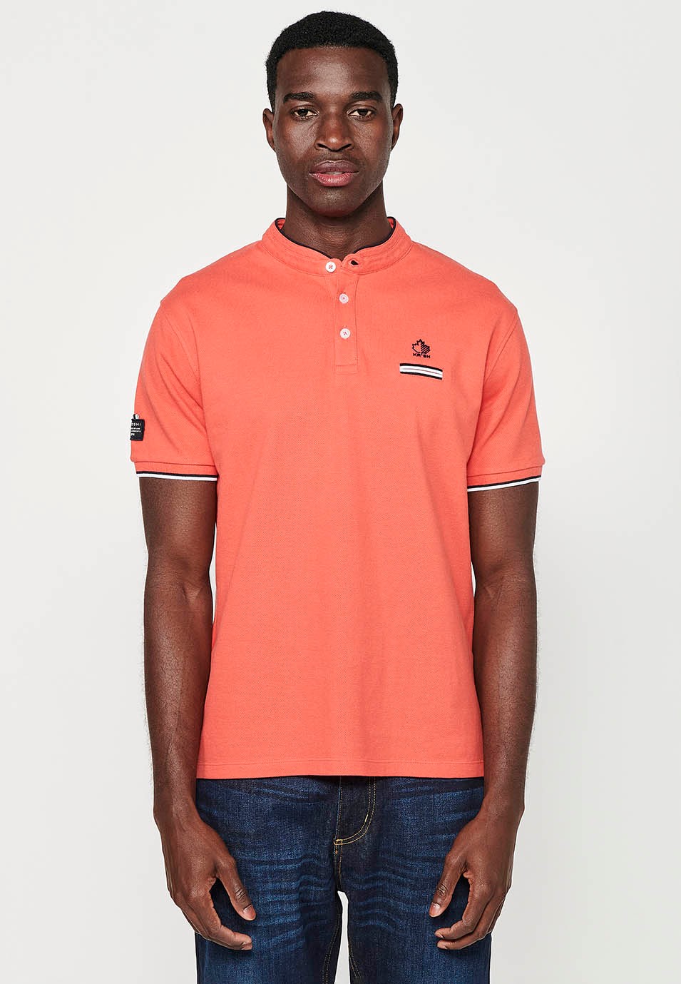 Short-sleeved cotton polo shirt with ribbed finish with round neck with buttoned opening and side slits in coral color for men 5