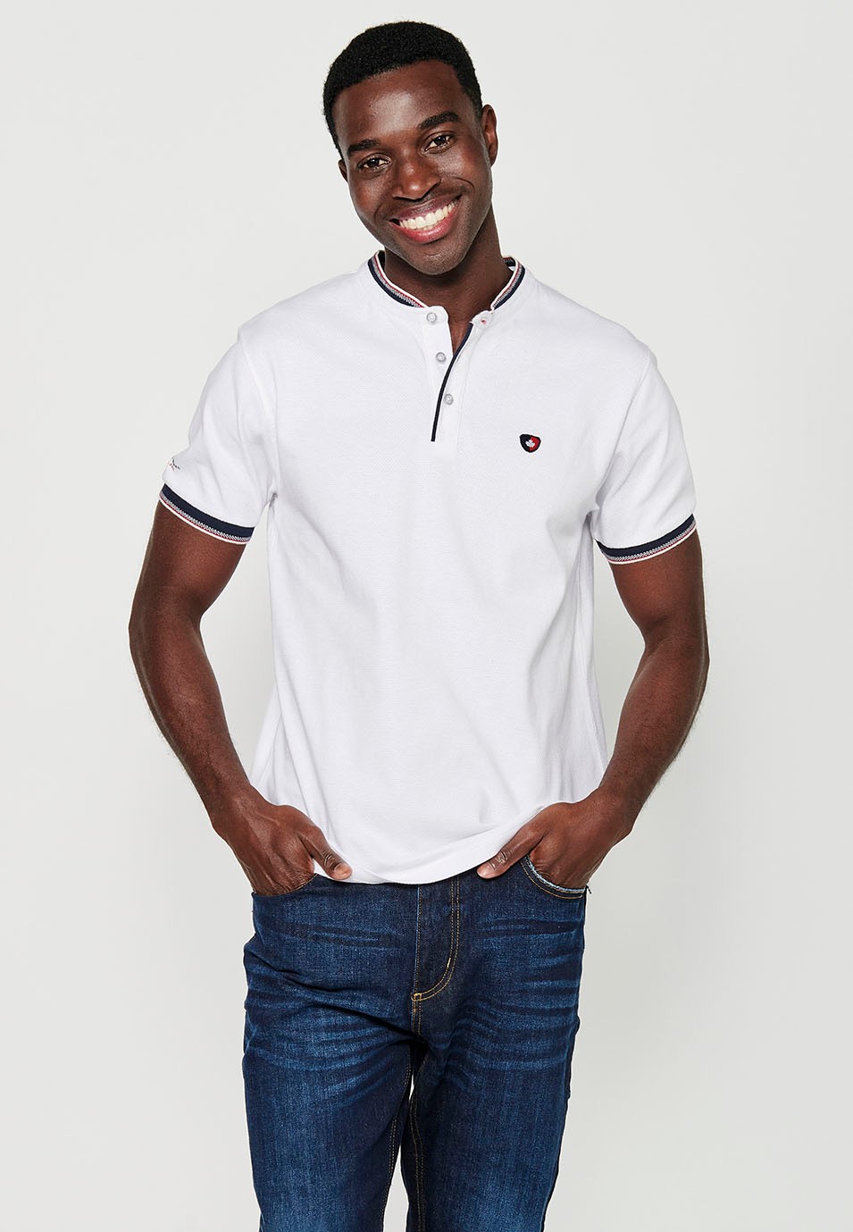 Short-sleeved cotton polo shirt finished in rib with a round neck with buttoned opening and textured with side slits in White for Men