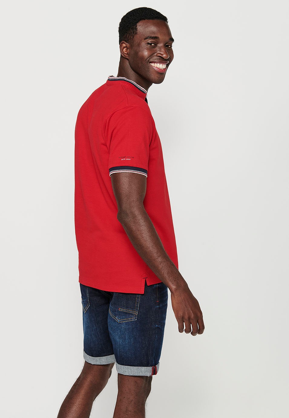 Short-sleeved cotton polo shirt finished in rib with a round neck with buttoned opening and textured with side slits in Red for Men 7