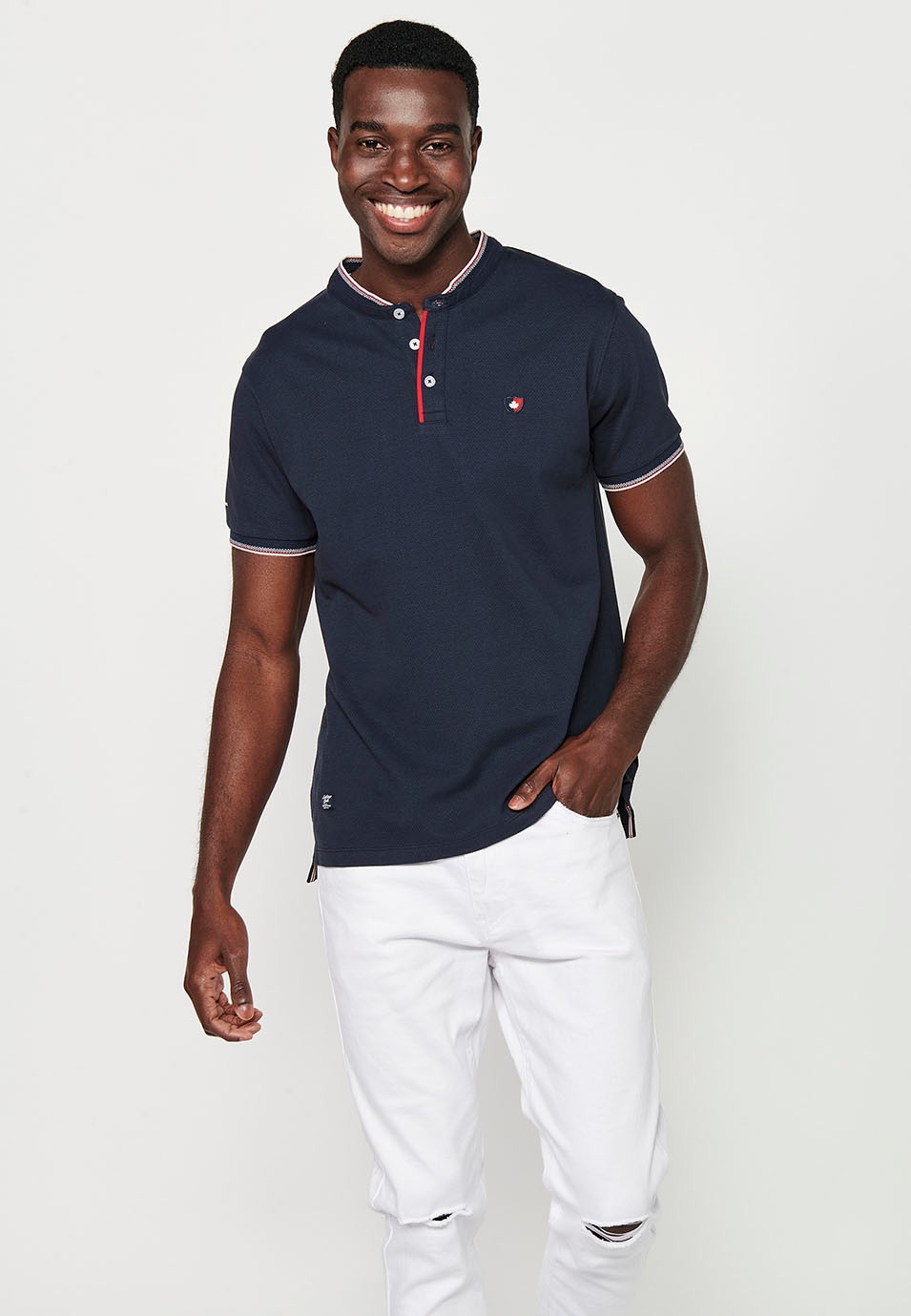 Short-sleeved cotton polo shirt with ribbed finish with round neck, buttoned opening and textured side slits in Navy Color for Men