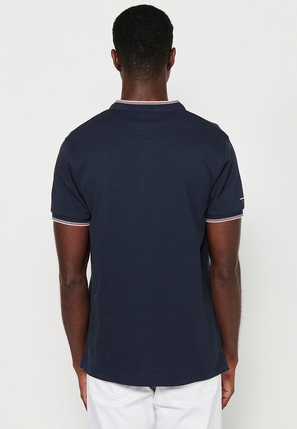 Short-sleeved cotton polo shirt with ribbed finish with round neck, buttoned opening and textured side slits in Navy Color for Men 7