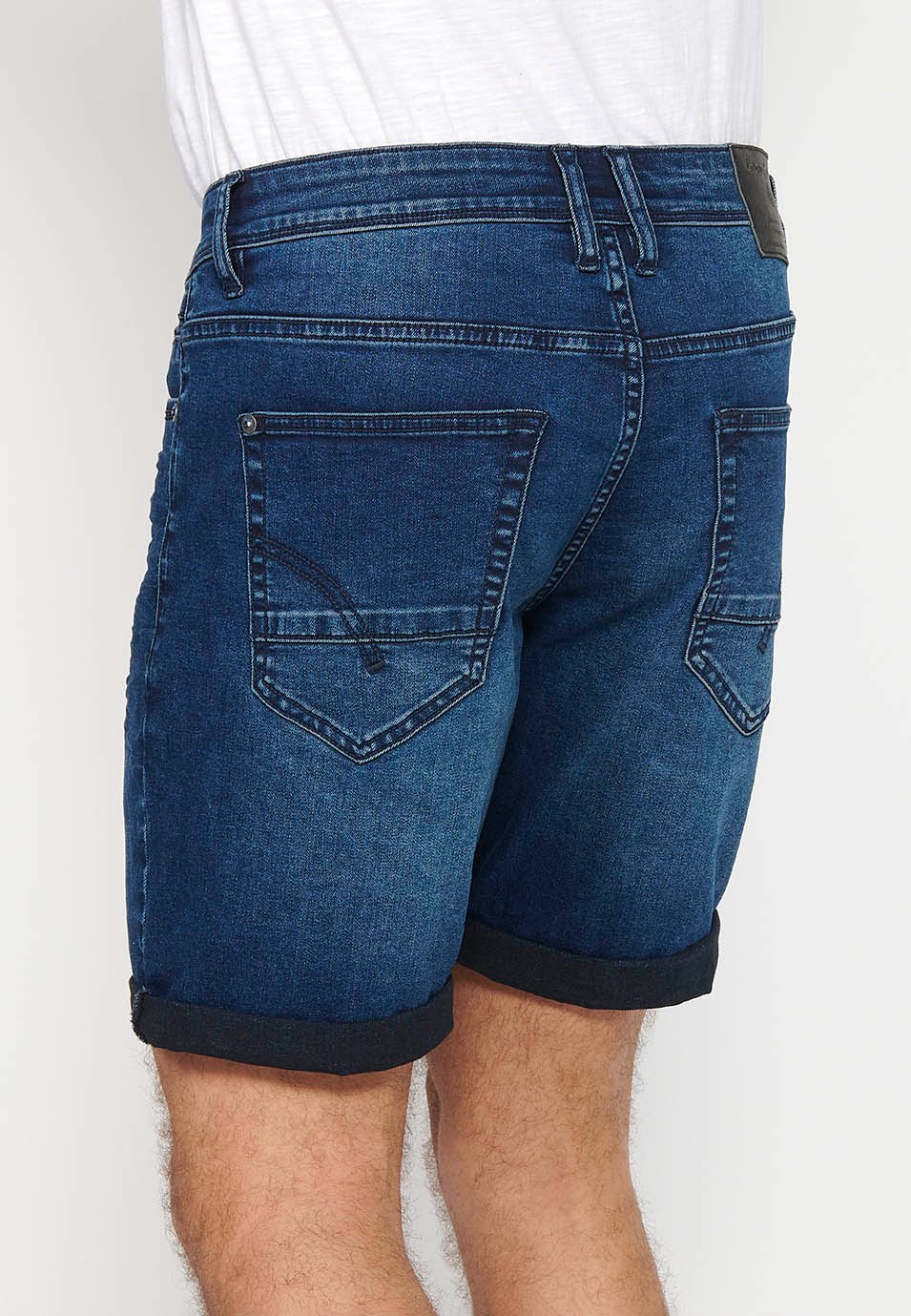 Short en jean avec fermeture éclair et bouton sur le devant et cinq poches, une poche de couleur bleue pour homme