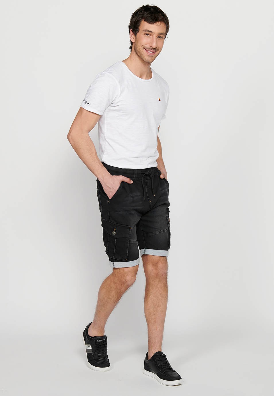 Denim Bermuda cargo jogger shorts finished with a turn-up, Adjustable waist with elastic and drawstring, Side pockets with flap, Black for Men 1