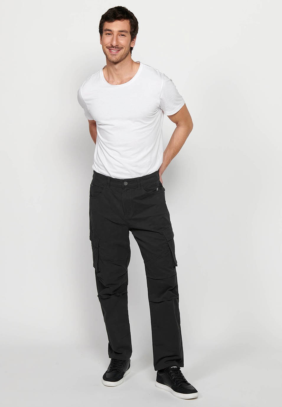 Long cargo pants with front zipper and button closure with side pockets with flap in Black for Men