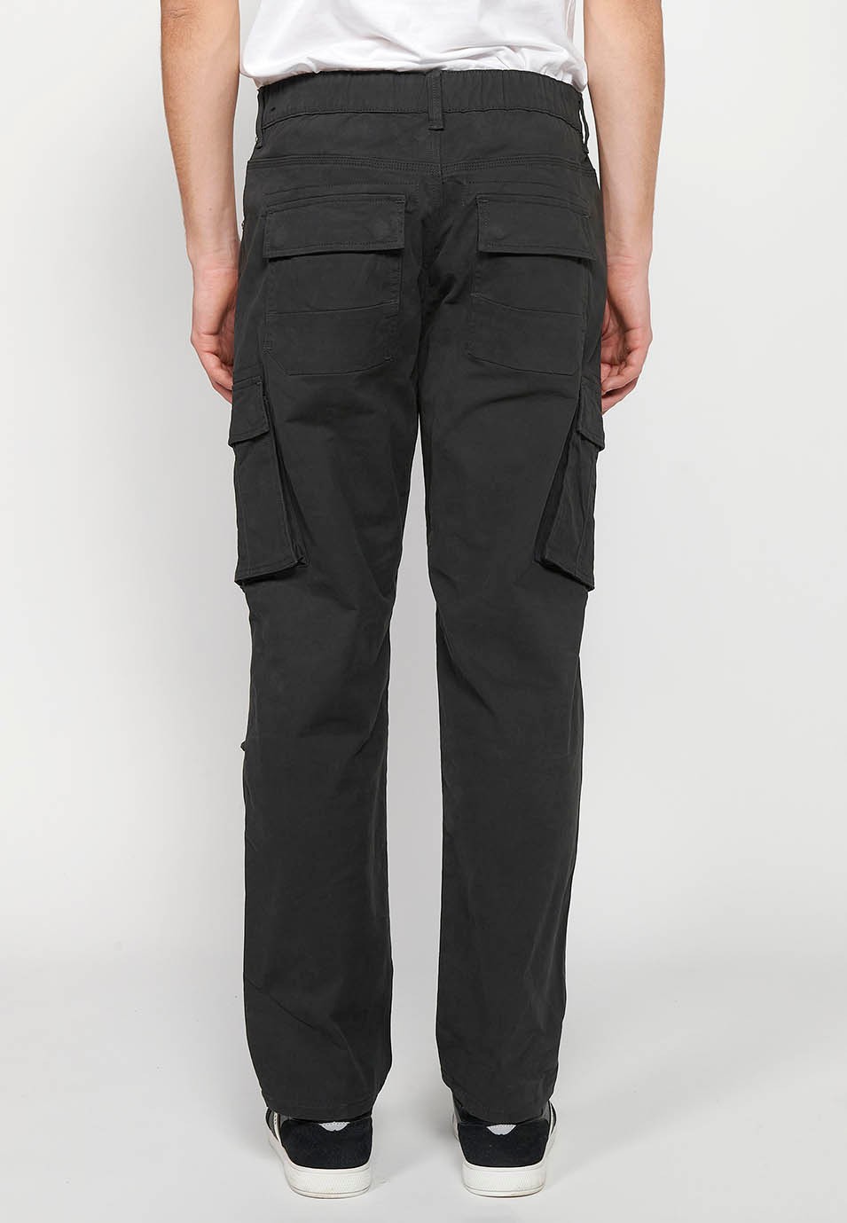 Long cargo pants with front zipper and button closure with side pockets with flap in Black for Men