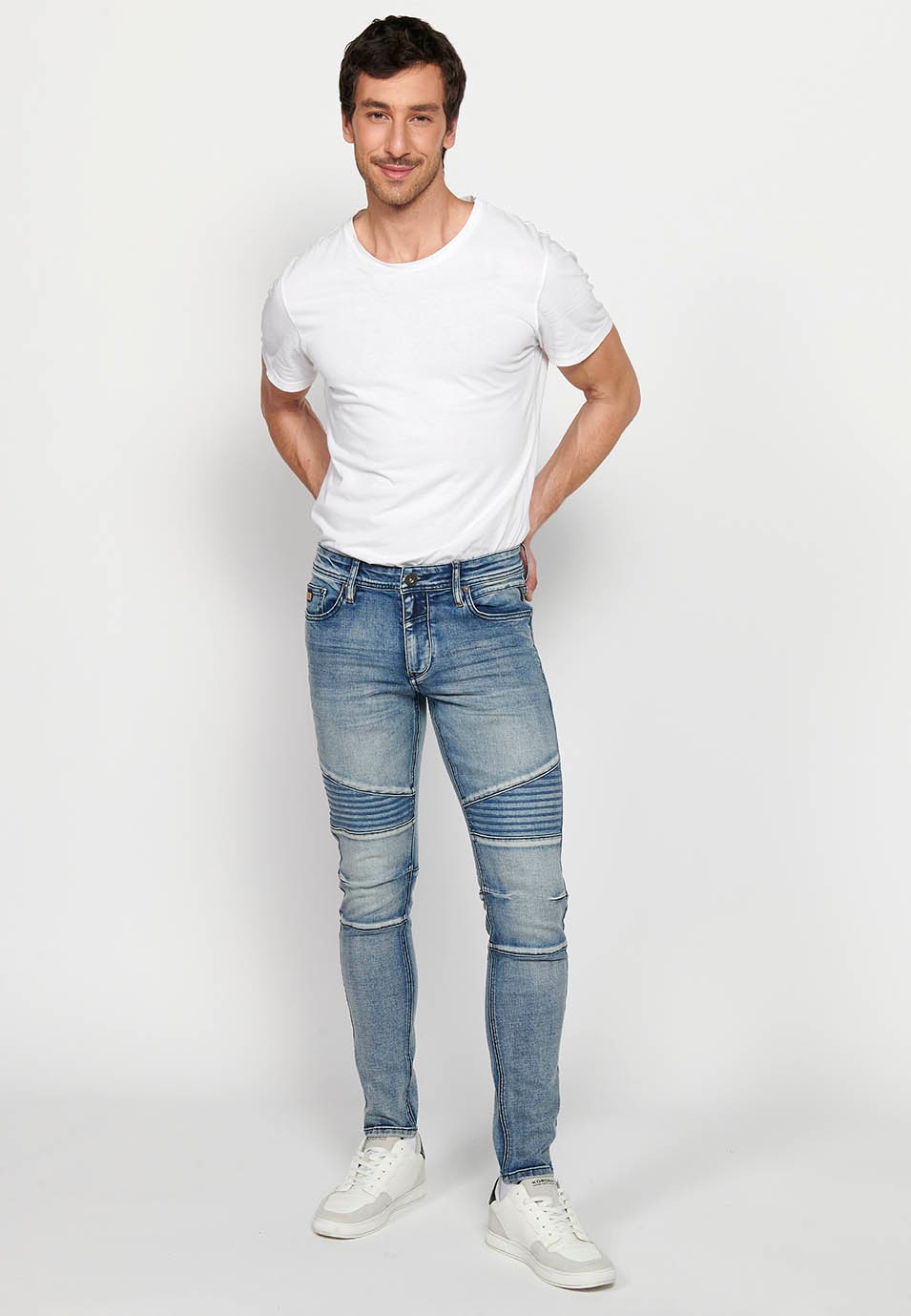 Long skinny fit biker jeans with front zipper and button closure and cut details on the knees in Blue for Men