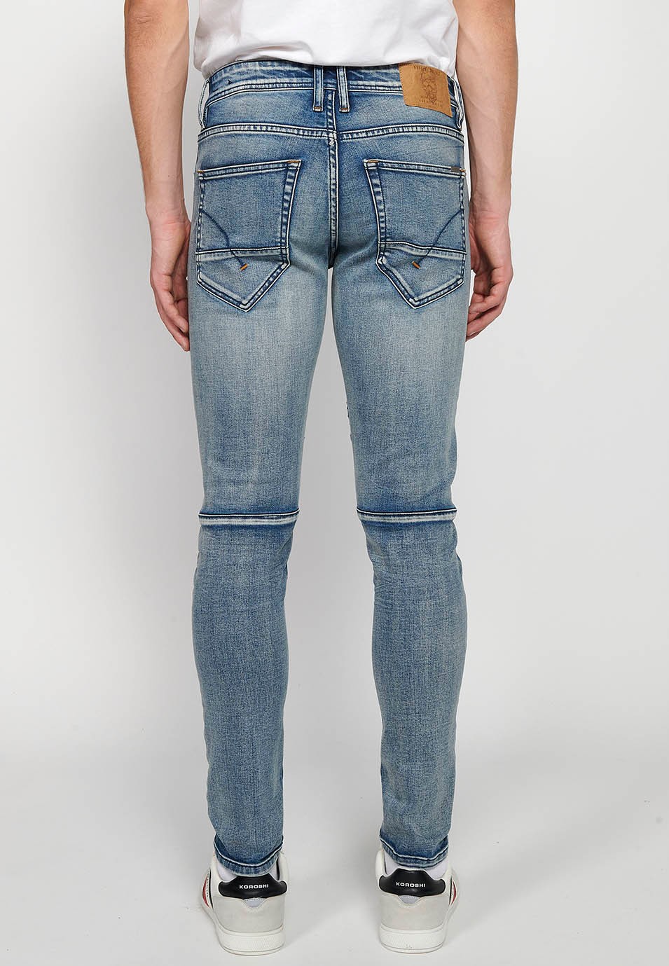 Long skinny fit biker jeans with front zipper and button closure and cut details on the knees in Blue for Men 4