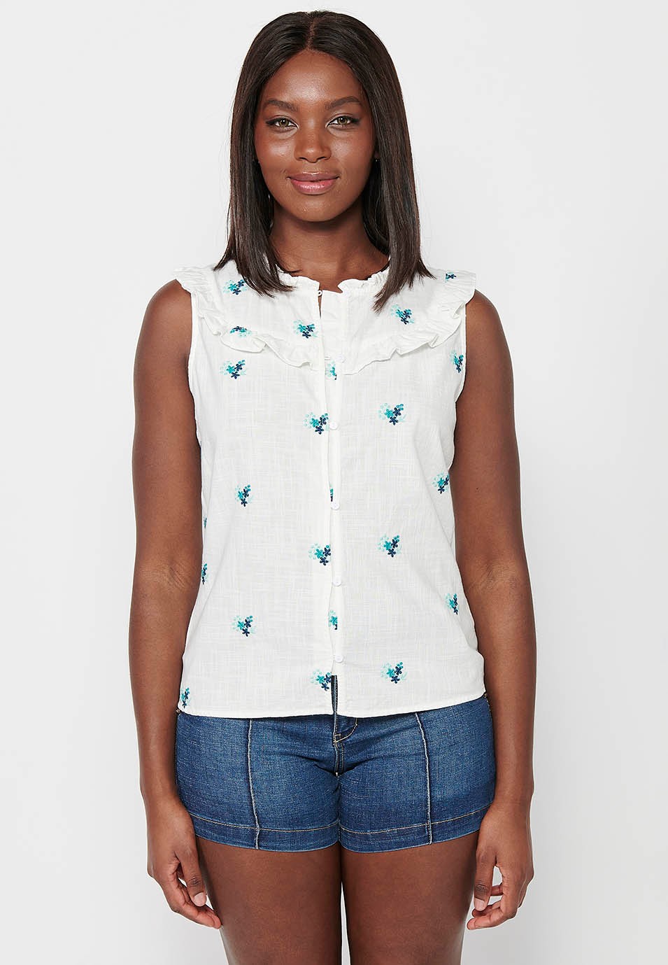 Sleeveless Cotton Blouse with Mini Ruffle on the shoulders with Fabric with floral embroidery and Round Neck and Front Closure with Elastic Buttons in White for Women