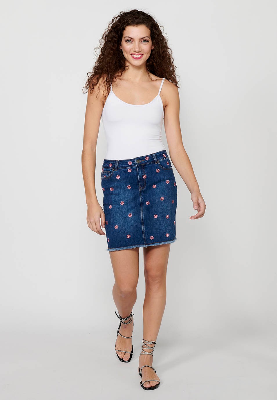 Short denim skirt made of embroidered fabric with front zipper closure and dark blue button for Women