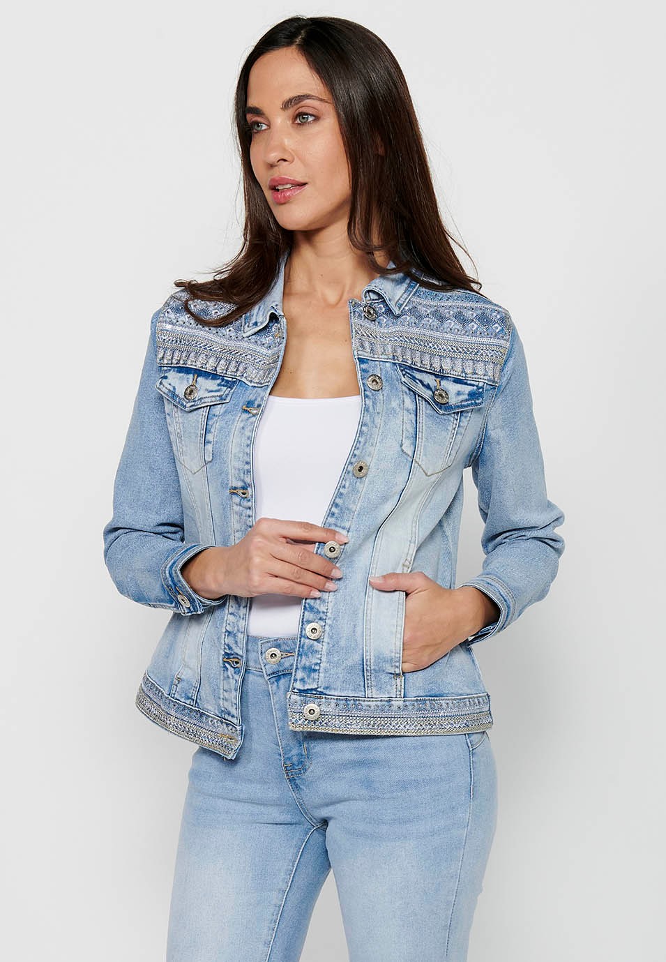 Denim jacket with front closure with buttons and shirt collar with pockets and embroidered details in light blue for women 1