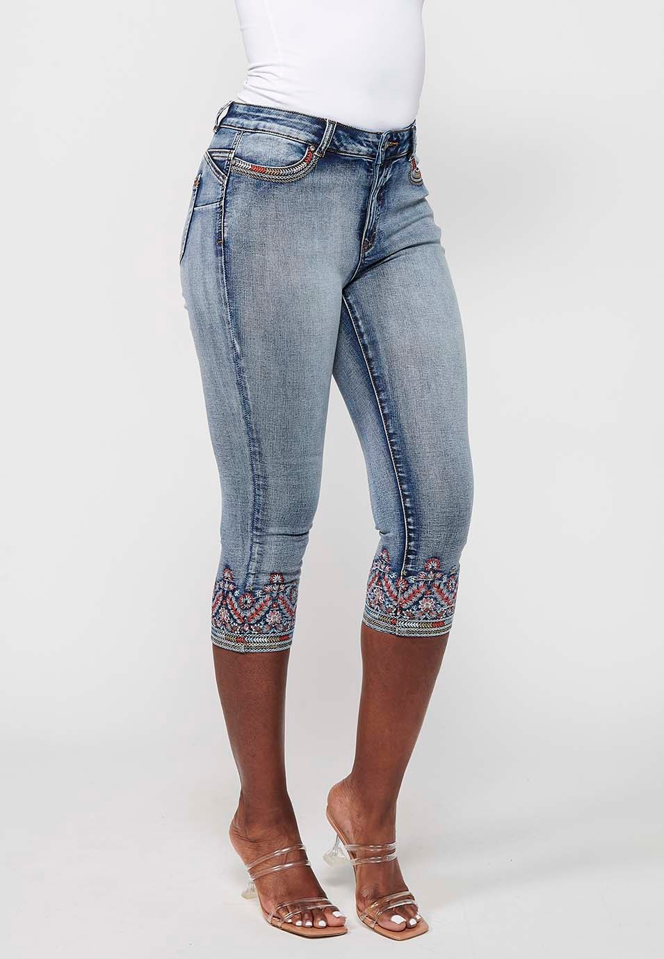 Pirate denim pants with embroidered details and worn effect in light blue for women