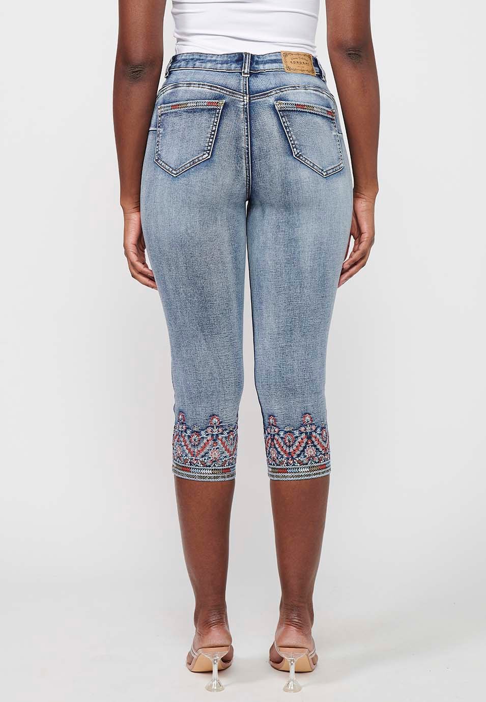 Pirate denim pants with embroidered details and worn effect in light blue for women