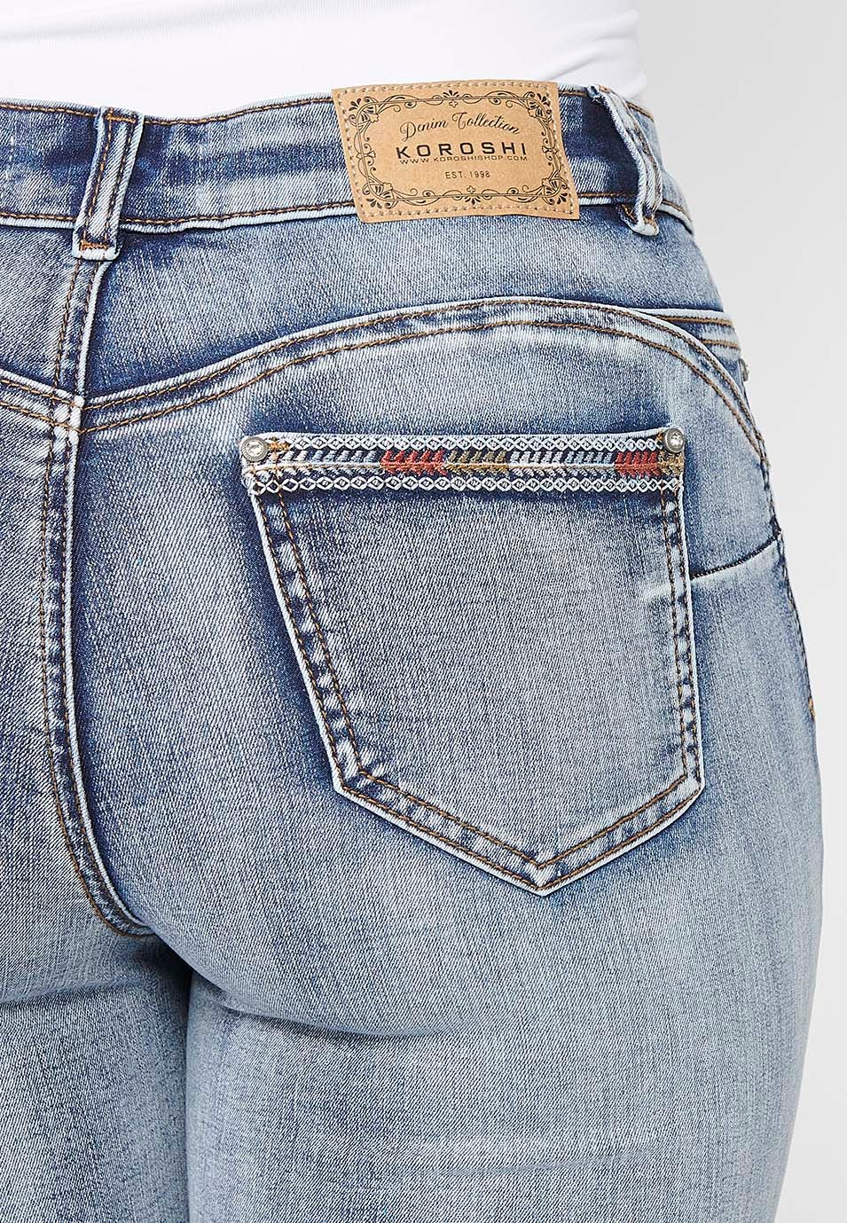 Pirate denim pants with embroidered details and worn effect in light blue for women