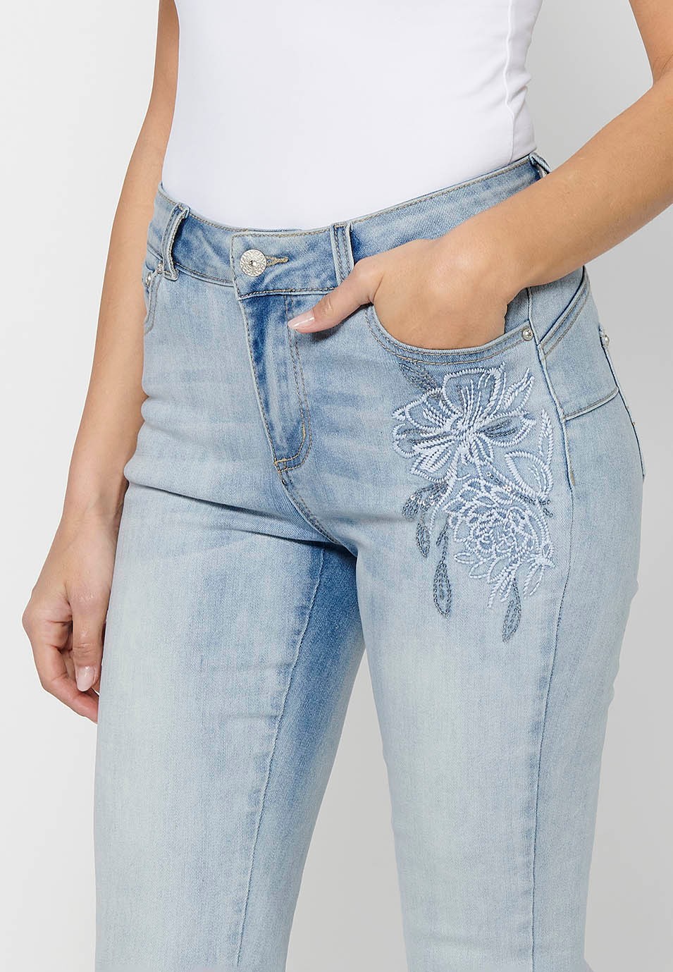 Slim long pants with front zipper and button closure with embroidered details in Light Blue for Women 8