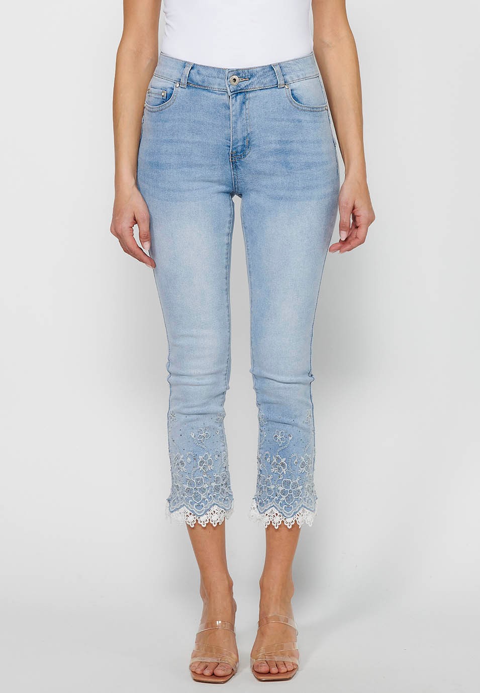 Long slim jeans pants with front zipper closure and light blue floral embroidered details for women 1