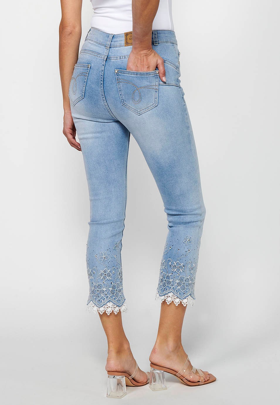 Long slim jeans pants with front zipper closure and light blue floral embroidered details for women 6