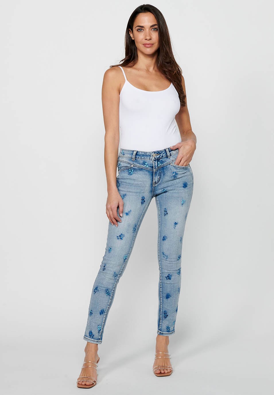 Slim long pants with front zipper and button closure with floral embroidery in Light Blue for Women