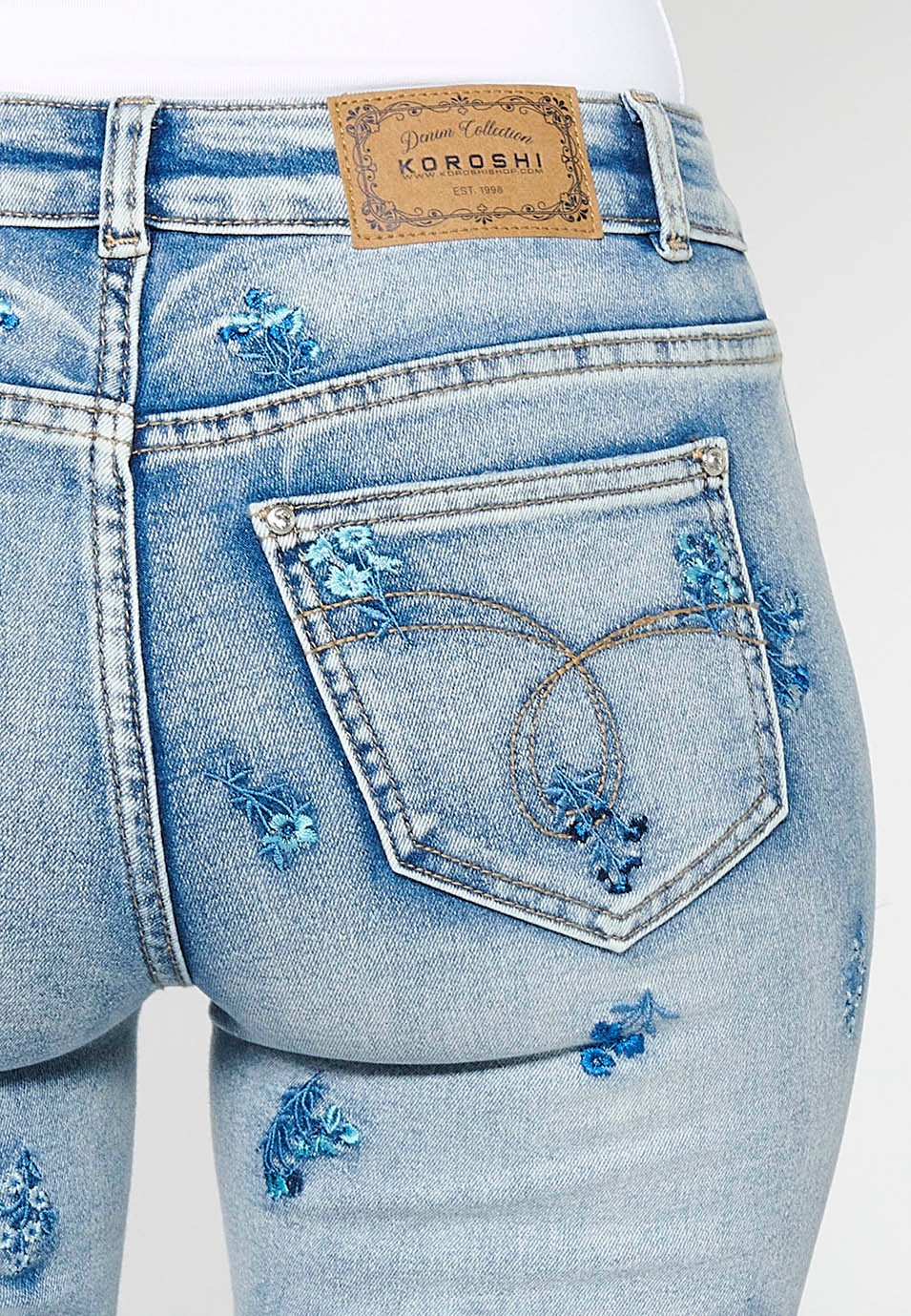 Pantalon long slim avec fermeture éclair sur le devant et fermeture boutonnée avec broderie florale en bleu clair pour femme 6