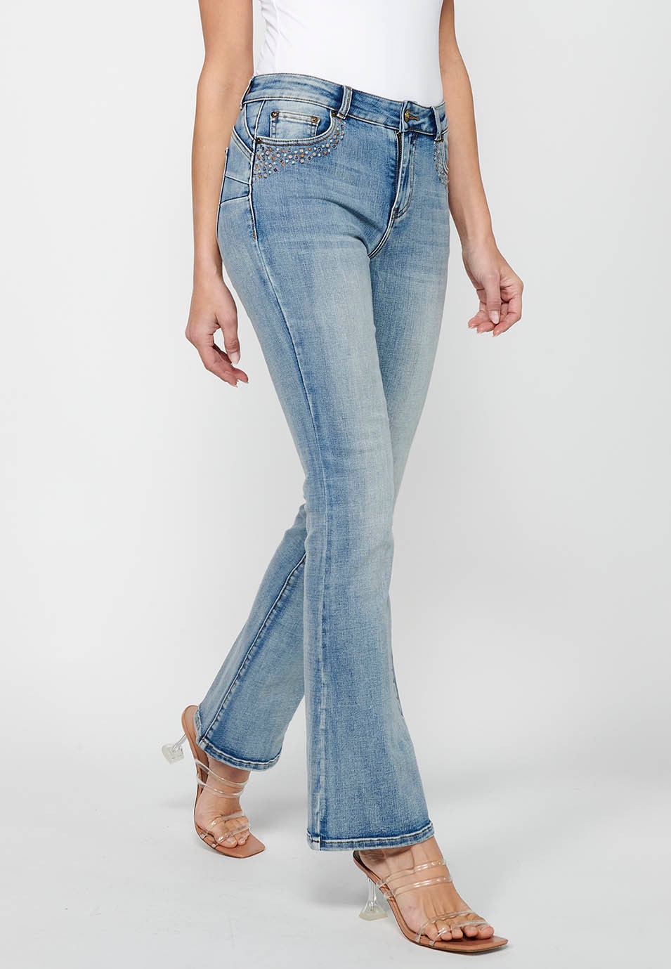 Long bell-bottom pants with front zipper and button closure with light blue ripped details for women 1