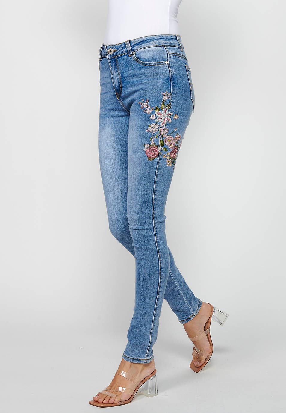 Slim long pants with front zipper and button closure with embroidered details in Blue for Women 1