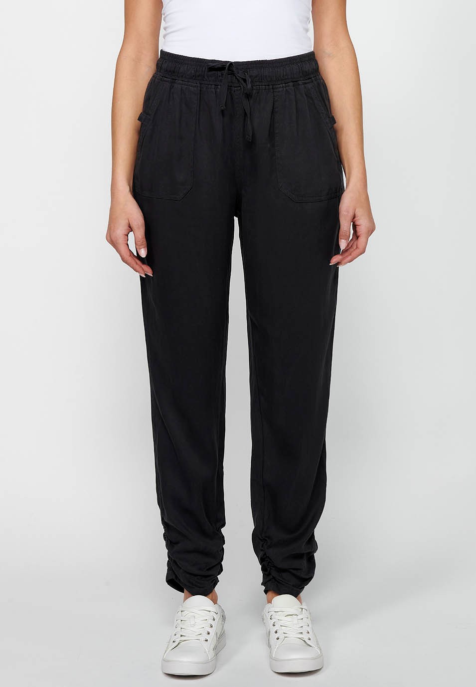 Long jogger pants with curled finish and rubberized waist with four pockets, two at the back with flap in Black for Women 4