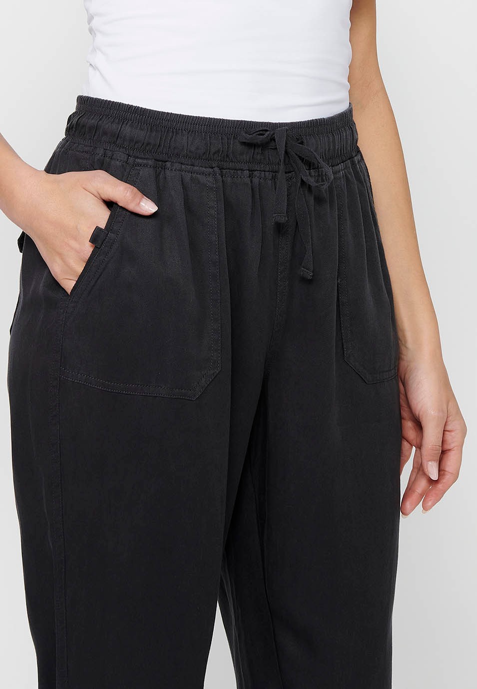 Long jogger pants with curled finish and rubberized waist with four pockets, two at the back with flap in Black for Women 7