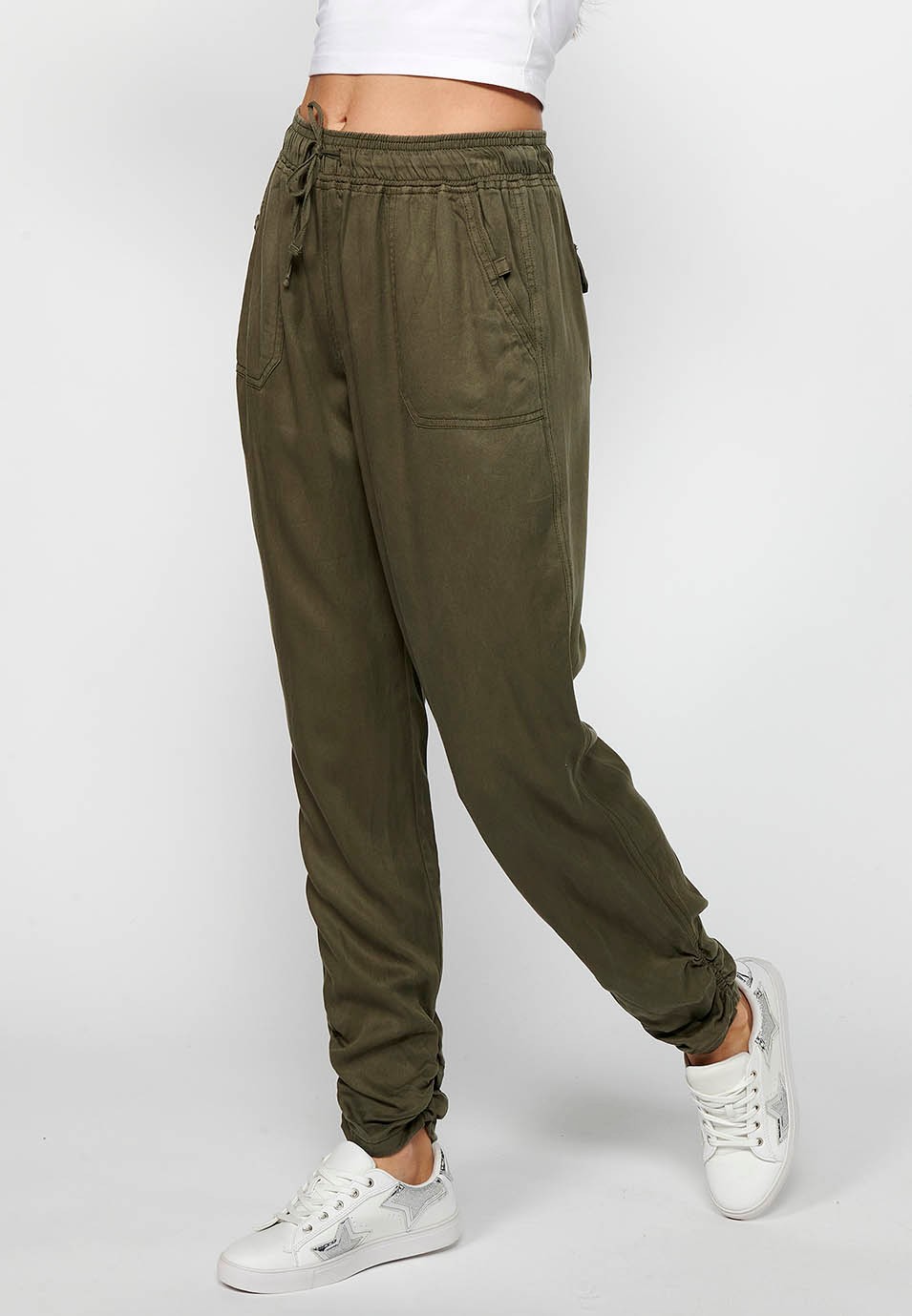 Long jogger pants with curled finish and rubberized waist with four pockets, two rear pockets with flap in Khaki color for women 2