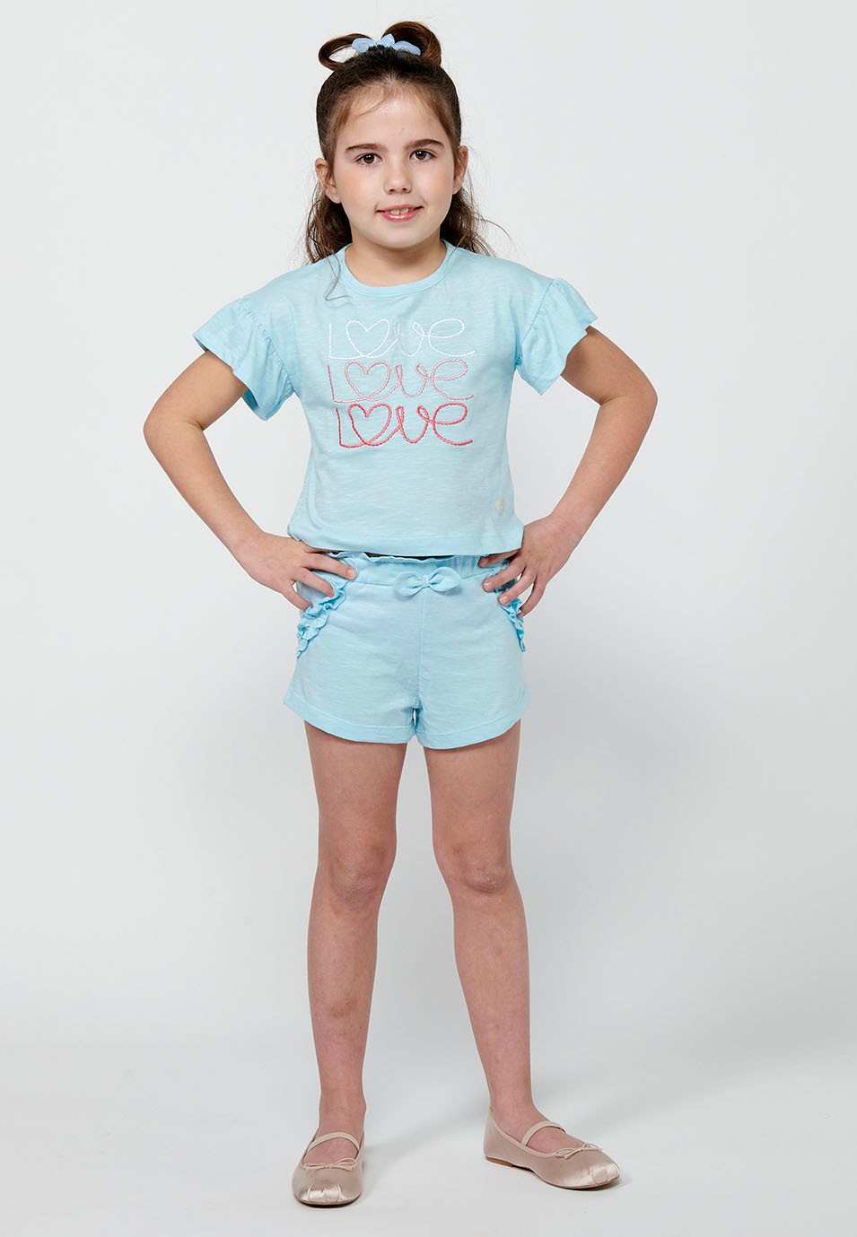 Conjunt de samarreta i pantalons. Samarreta de màniga curta amb estampat davanter i Pantalons curts amb cintura engomada de Color Blau per a Nena