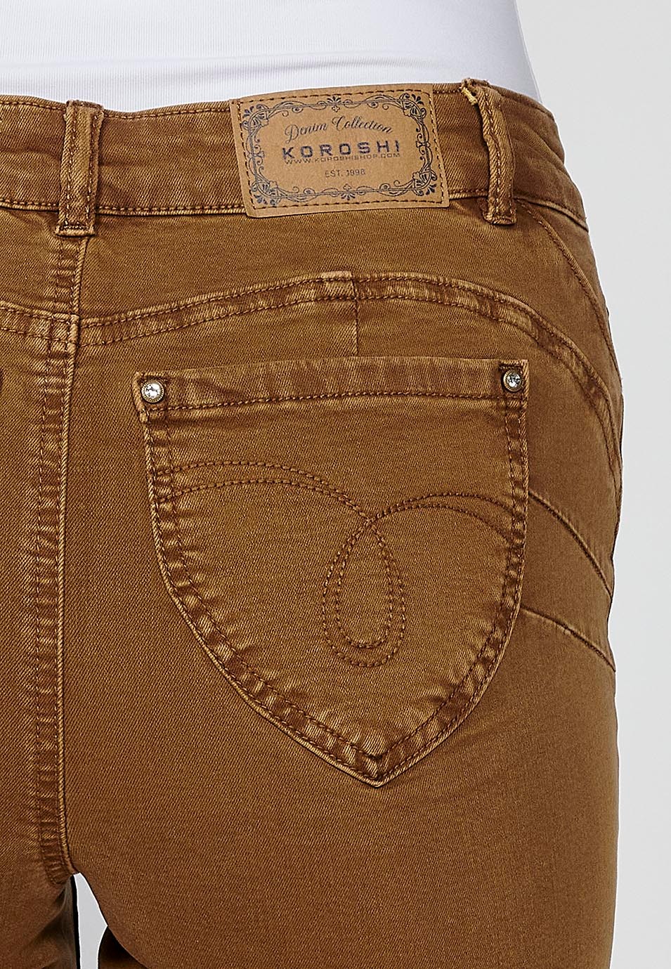 Lange, schmal geschnittene Damenhose mit gestickten Details und Reißverschluss und Knopfverschluss vorne in der Farbe Ocker