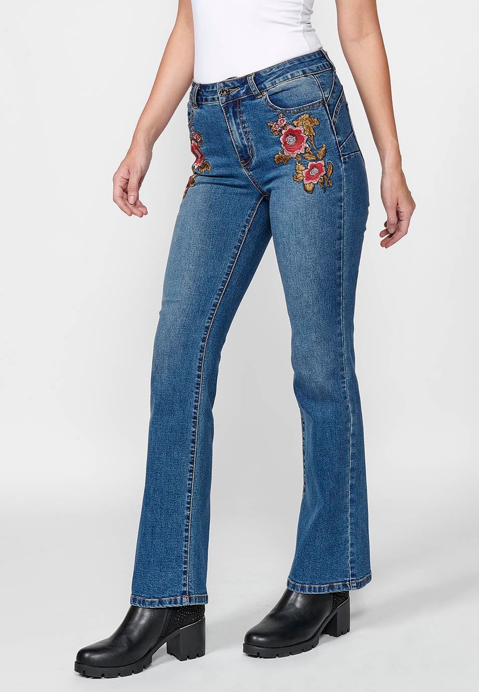 Women's blue flared boot cut denim trousers with five pockets and embroidered flowers on the hip