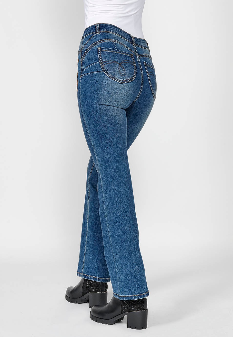 Women's blue flared boot cut denim trousers with five pockets and embroidered flowers on the hip