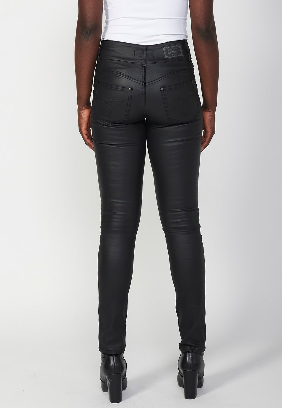 Slim fit denim long trousers with five push-up pockets and front zip and button closure with embroidered details for women in black