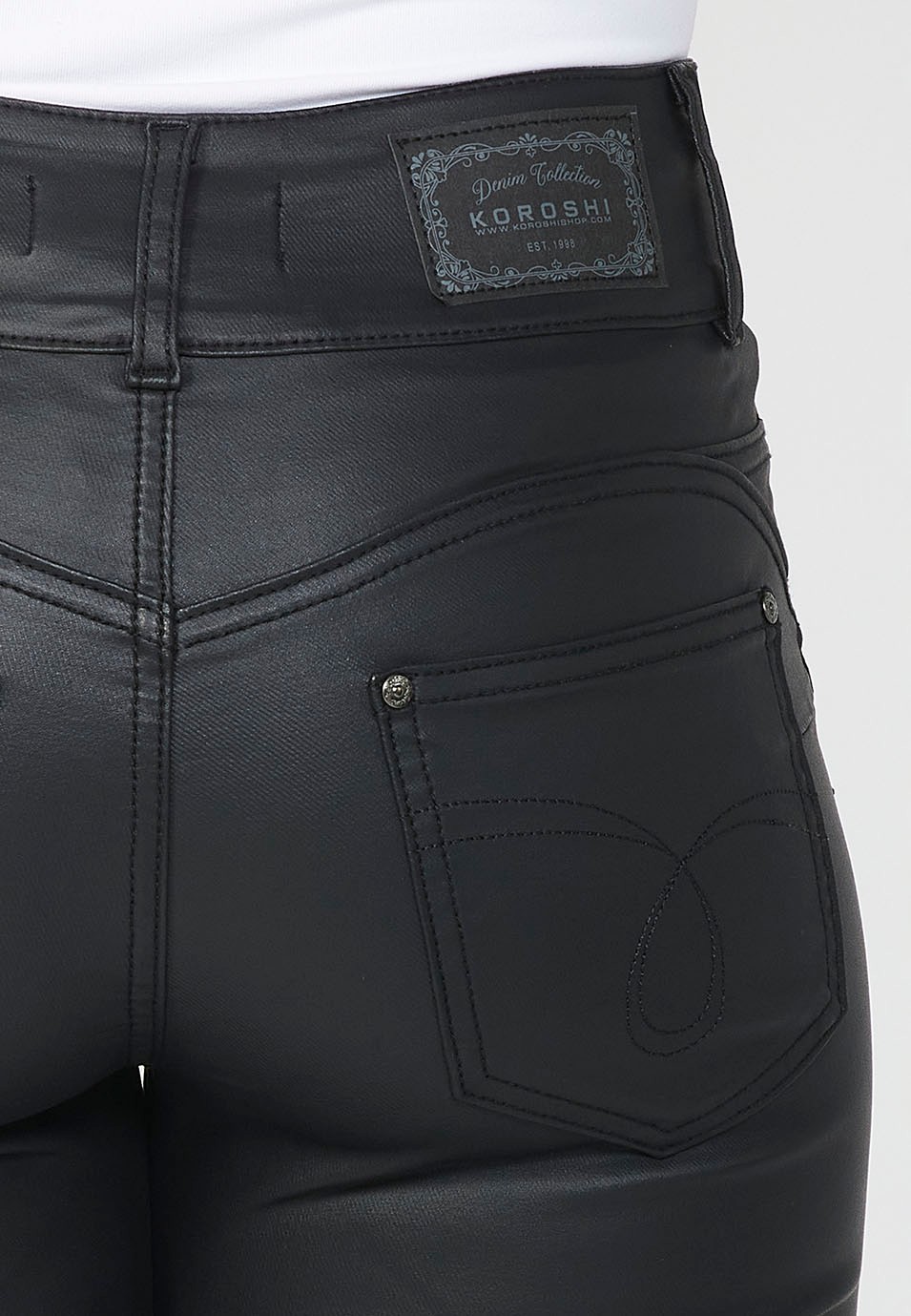 Slim fit denim long trousers with five push-up pockets and front zip and button closure with embroidered details for women in black