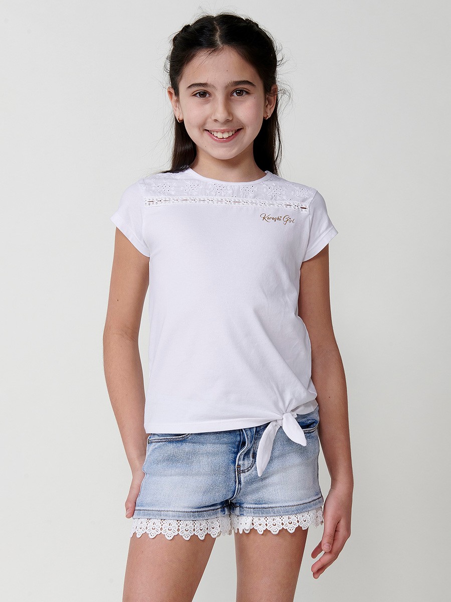 Girls' white top with waist tie, mesh yoke, and gold Koröshi logo