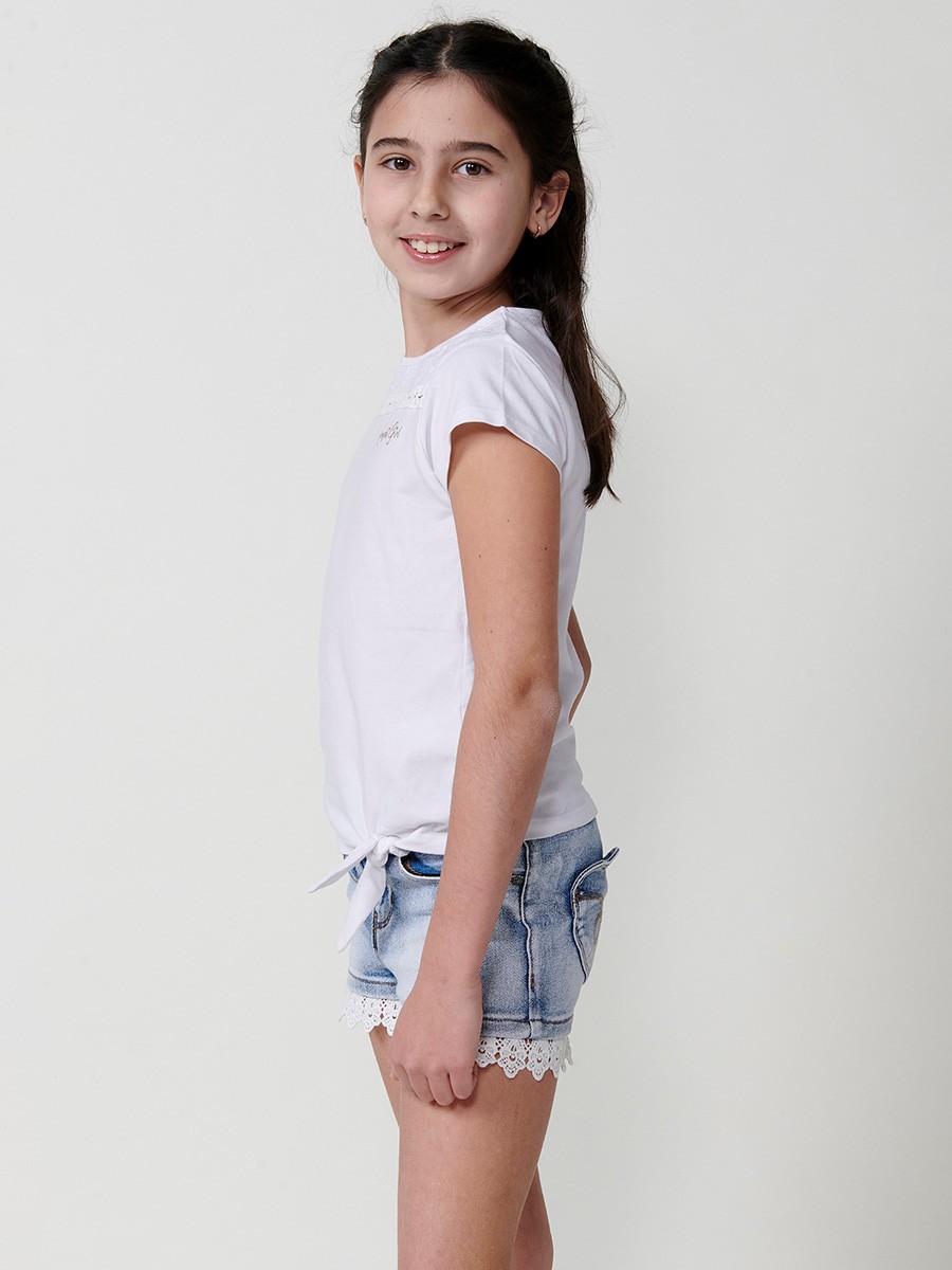 Girls' white top with waist tie, mesh yoke, and gold Koröshi logo