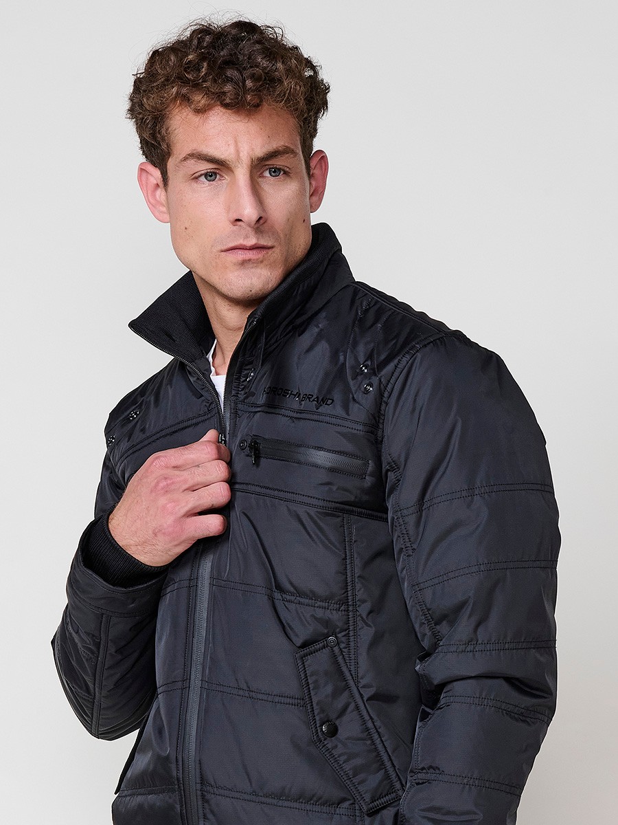 Gesteppte schwarze Herrenjacke mit hohem Kragen, Reißverschluss und Taschen. Aus 100 % Polyester, strapazierfähig und warm.