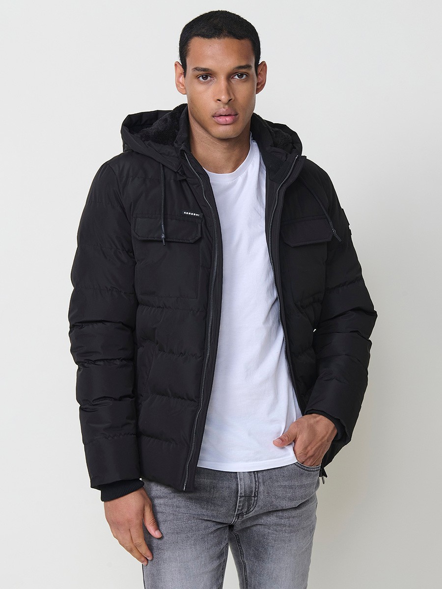 Gesteppte schwarze Herrenjacke mit hohem Kragen, Kapuze, Reißverschluss und Taschen. Aus 100 % Polyester, warm und strapazierfähig.