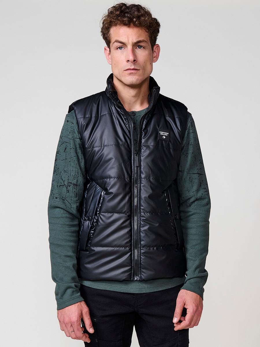 Schwarze gesteppte Herrenweste mit hohem Kragen und Frontreißverschluss. Aus 100 % Polyester, warm, leicht und strapazierfähig.