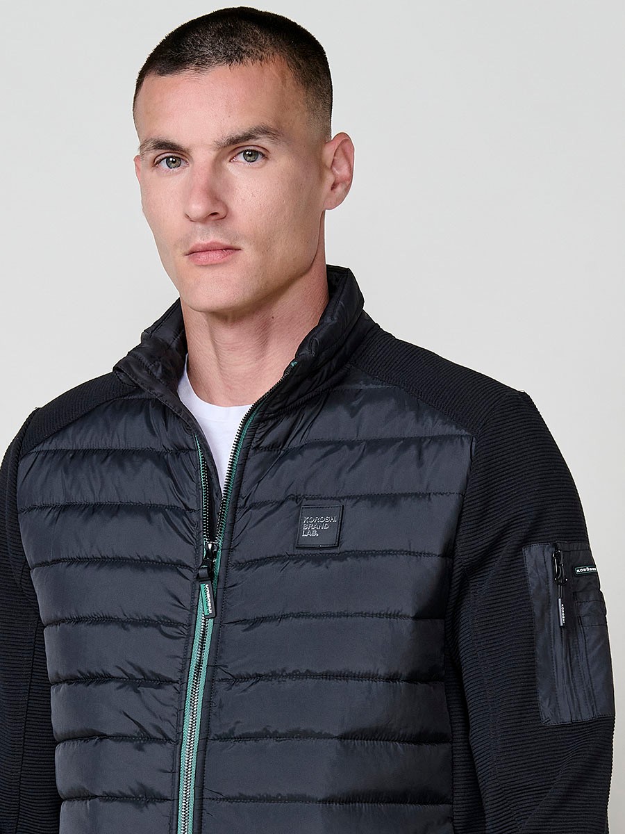 Chaqueta de hombre negra acolchada en felpa, confeccionada en 100% poliéster. Cálida, ligera y versátil, ideal para looks urbanos y casuales.